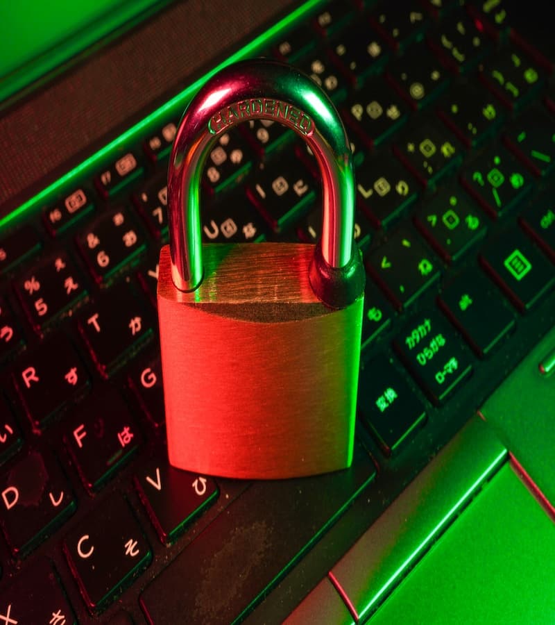 A padlock resting on a laptop keyboard, representing cybersecurity